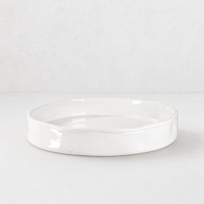 Handmade Montes Doggett ceramic tray, creamy white glaze, 11" round, wavy rim.