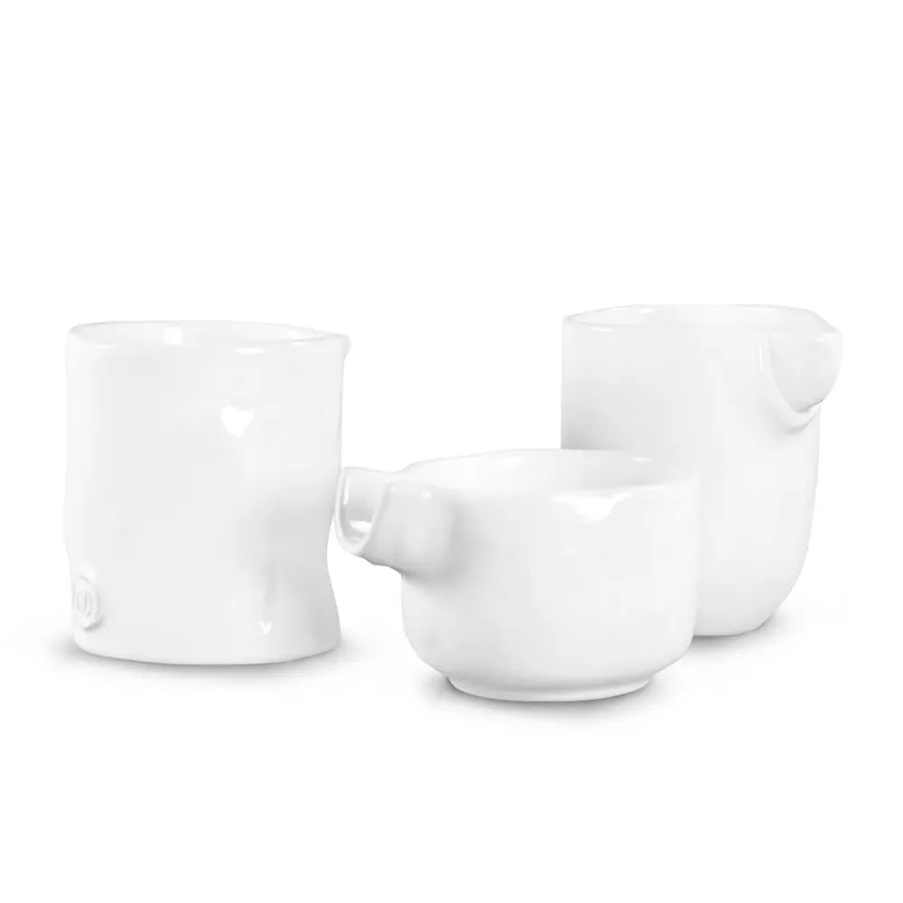 Set of 3 handmade Montes Doggett creamy white ceramic tumblers, various sizes, unique designs.
