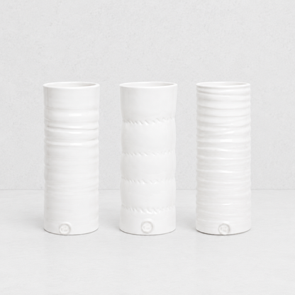 Set of 3 handmade Montes Doggett ceramic vases, creamy white glaze, varying textured designs.