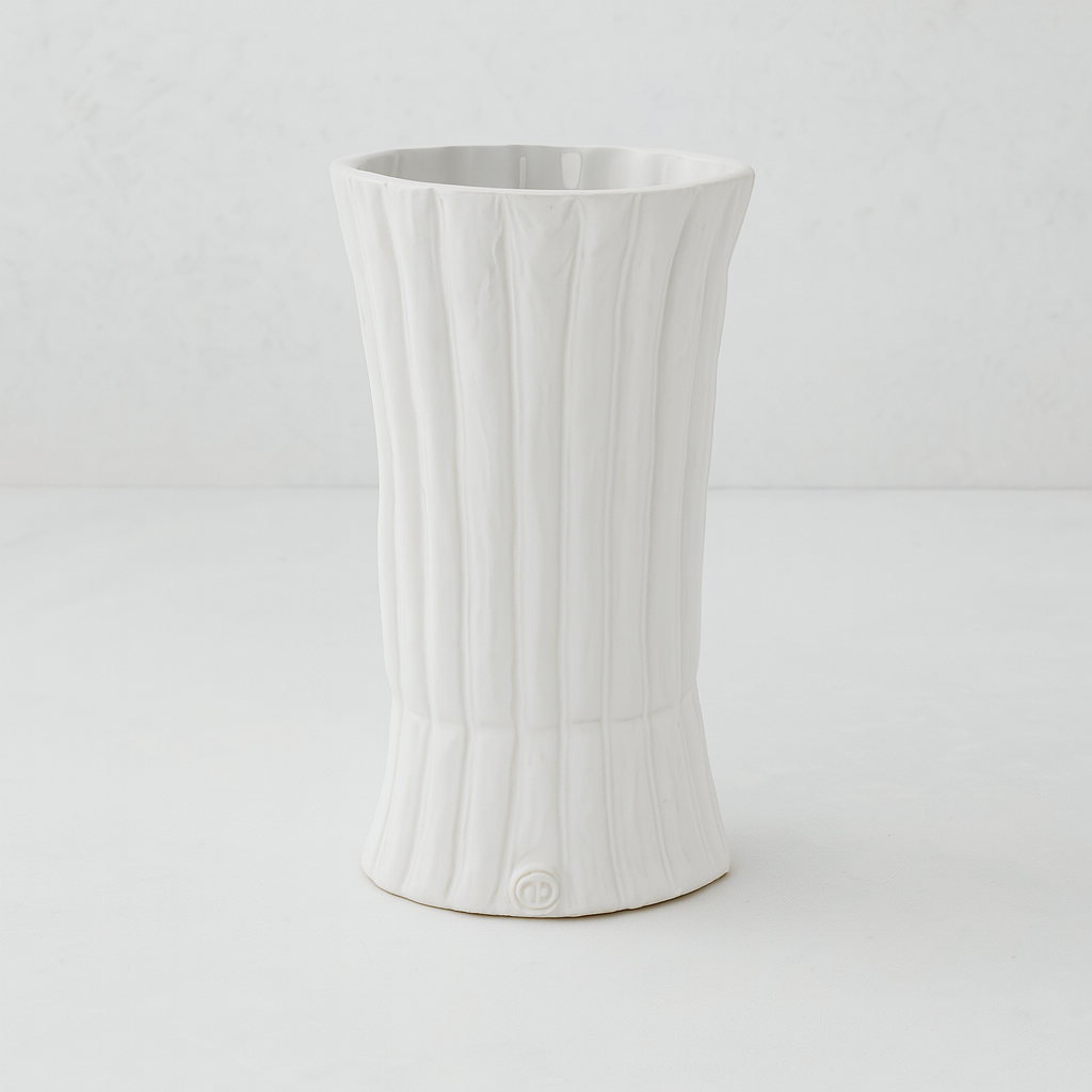 Handmade creamy white ceramic vase by Montes Doggett, 11.5"H, with vertical ridges and a flared base.