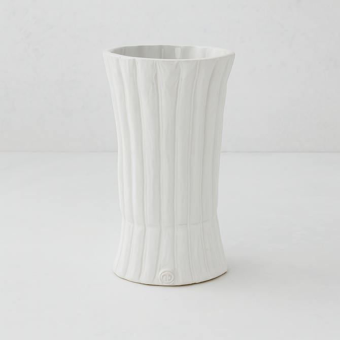 Handmade creamy white ceramic vase by Montes Doggett, 11.5"H, with vertical ridges and a flared base.