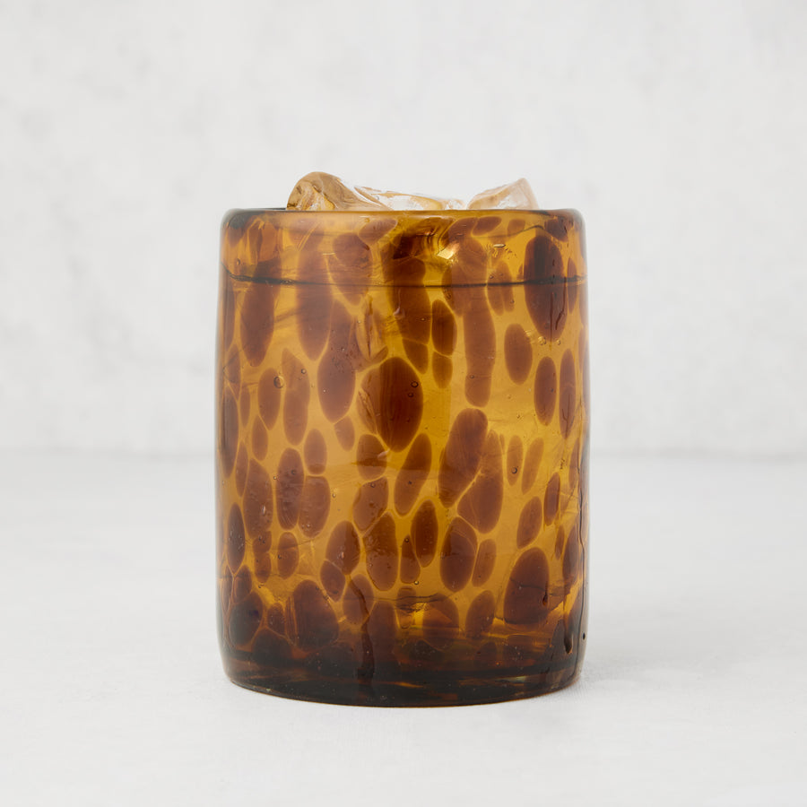 Handmade 12 oz. mouth-blown amber tortoise double old-fashioned glass with ice.