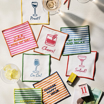 Set of 4 "Happy Hour" striped embroidered cotton coasters in orange, green, blue, and pink.