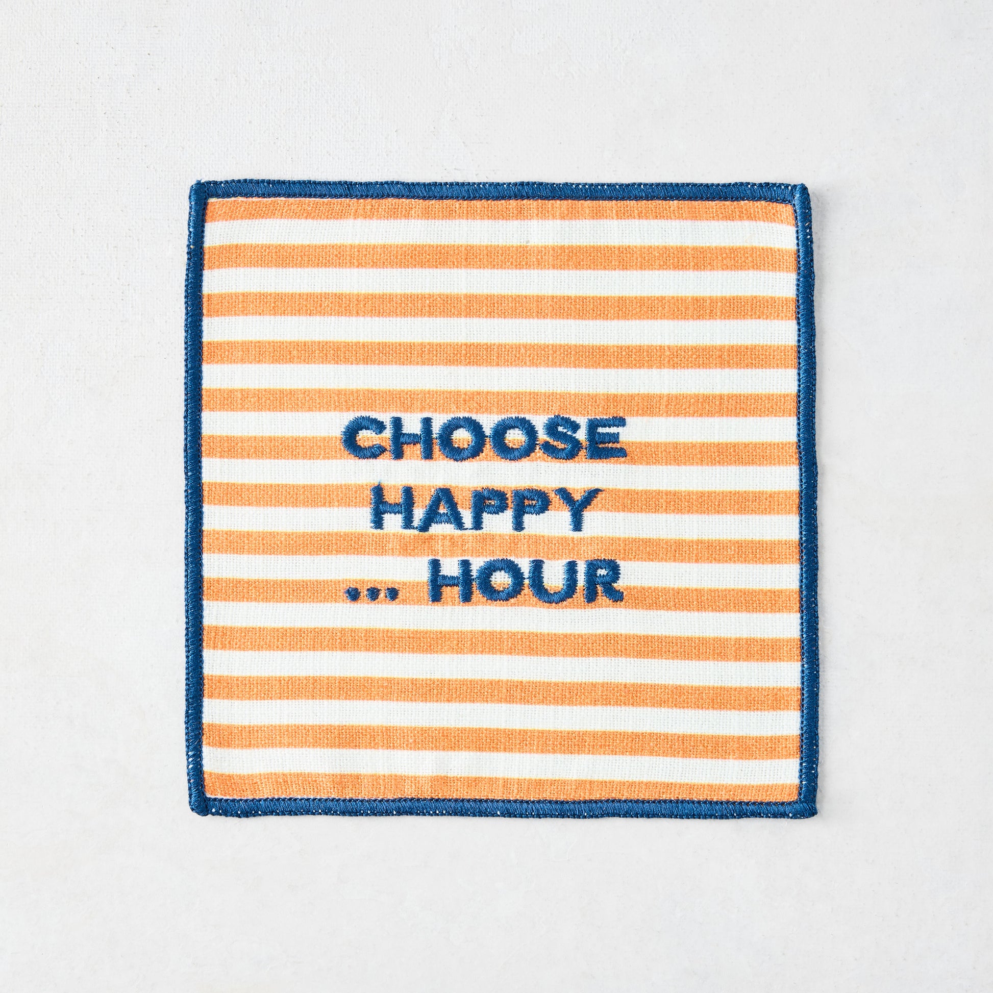 Cotton coaster with orange and white stripes, blue embroidered border, and "CHOOSE HAPPY ... HOUR" text.