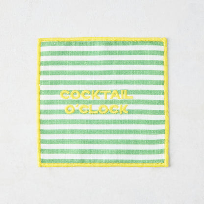 Green and white striped cotton coaster with yellow "COCKTAIL O'CLOCK" embroidery and yellow border.