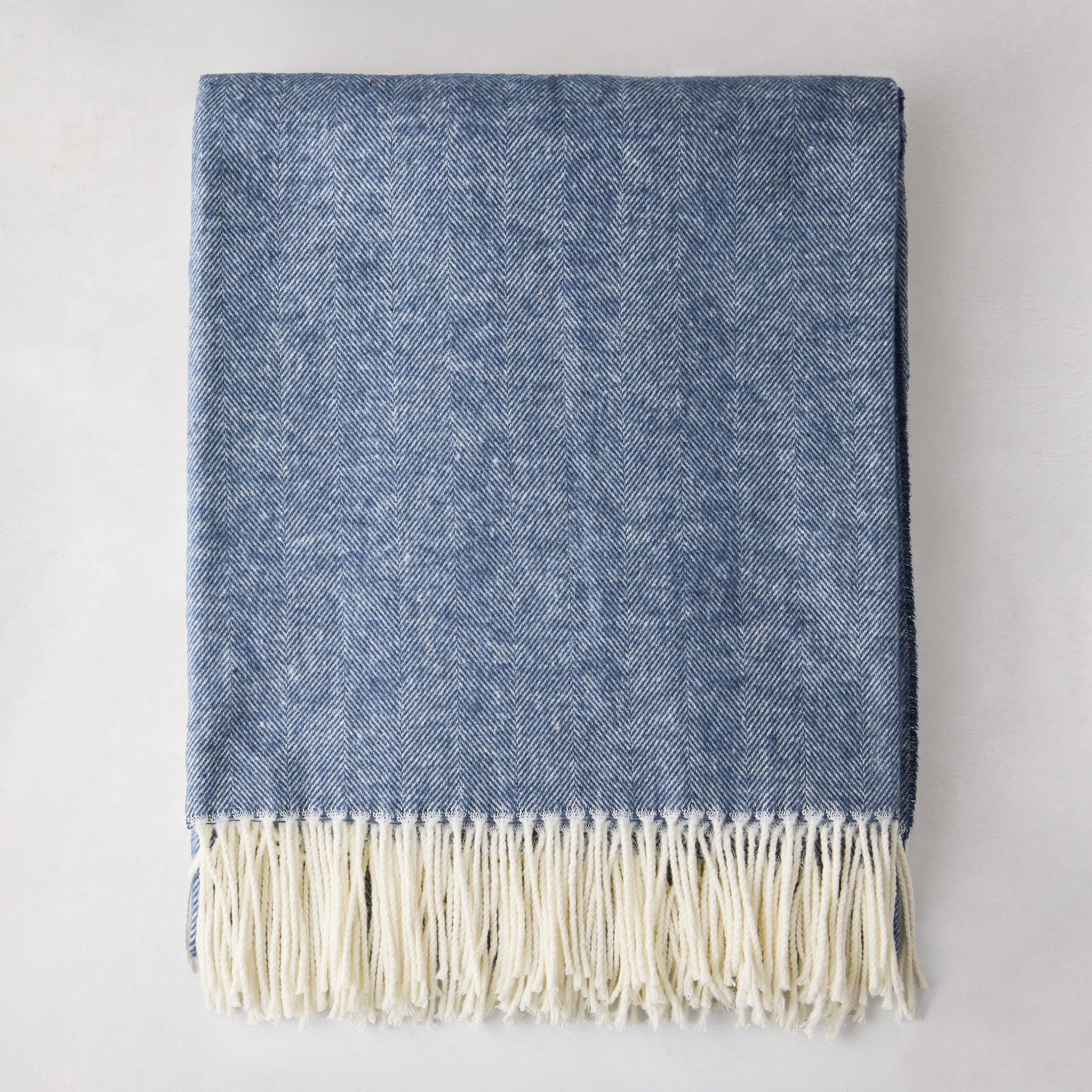Harbor Blue Italian Herringbone Throw Blanket, 51"x67" cotton-acrylic, with white fringe.