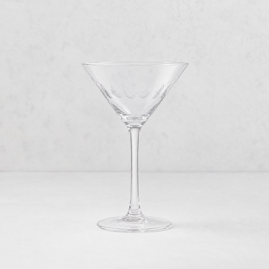 Clear lead-free crystal martini glass with hand-cut oval detailing on a slender stem against a neutral background.