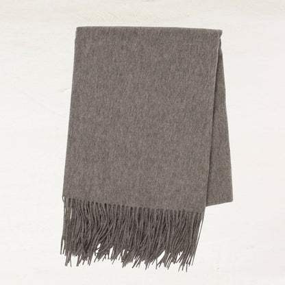 Heather grey cashmere throw blanket with classic fringe.