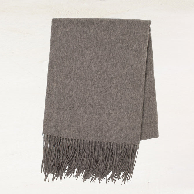 Heather grey cashmere throw blanket with classic fringe.