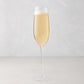 HG Heritage Champagne Glass, clear mouth-blown glass, filled with bubbly champagne.