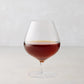 HG Heritage 20 oz mouth-blown clear glass cognac snifter with amber liquid.
