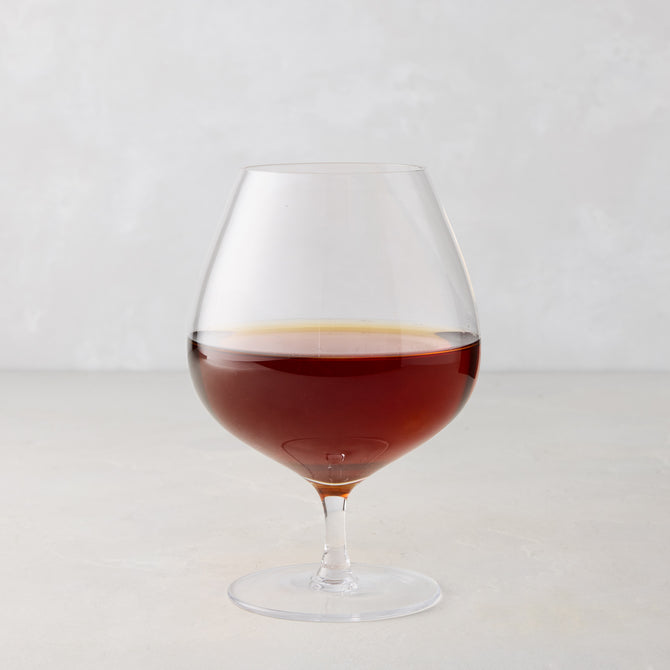 HG Heritage 20 oz mouth-blown clear glass cognac snifter with amber liquid.