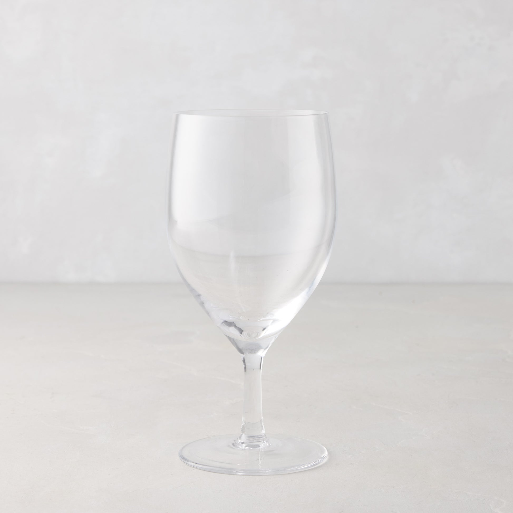 Clear, mouth-blown HG Heritage Water Glass, 6.3"H x 3"Dia, 12oz, with a thin stem and wide base.
