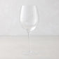 Clear, tall HG Heritage mouth-blown wine glass with a thin stem and wide bowl.