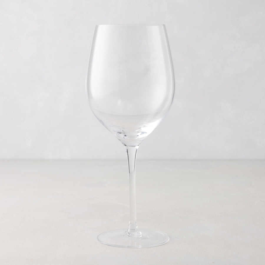 Clear, tall HG Heritage mouth-blown wine glass with a thin stem and wide bowl.