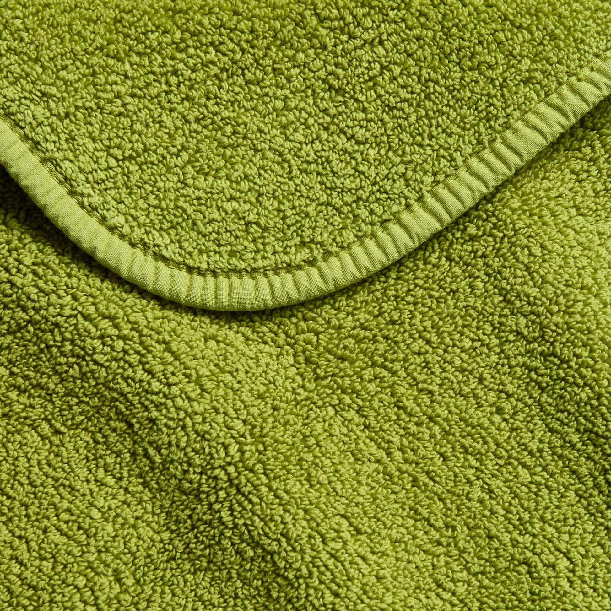 Aloe green zero twist cotton bath towel with textured terry fabric and matching bias piping trim.