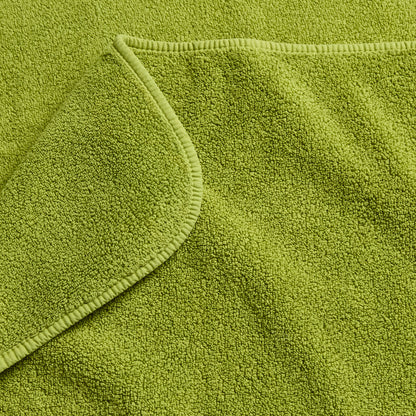 Aloe green zero-twist cotton bath towel with matching bias piping detail.