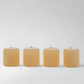 Set of 4 HG Amber Unscented 2" Votive Candles, hand-dipped paraffin with gold HG logo.