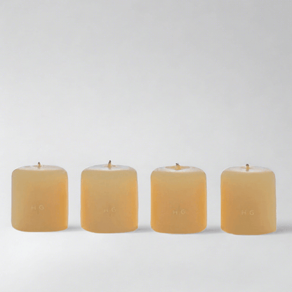Set of 4 HG Amber Unscented 2" Votive Candles, hand-dipped paraffin with gold HG logo.