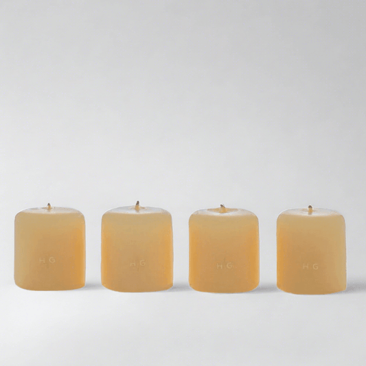 Set of 4 HG Amber Unscented 2" Votive Candles, hand-dipped paraffin with gold HG logo.