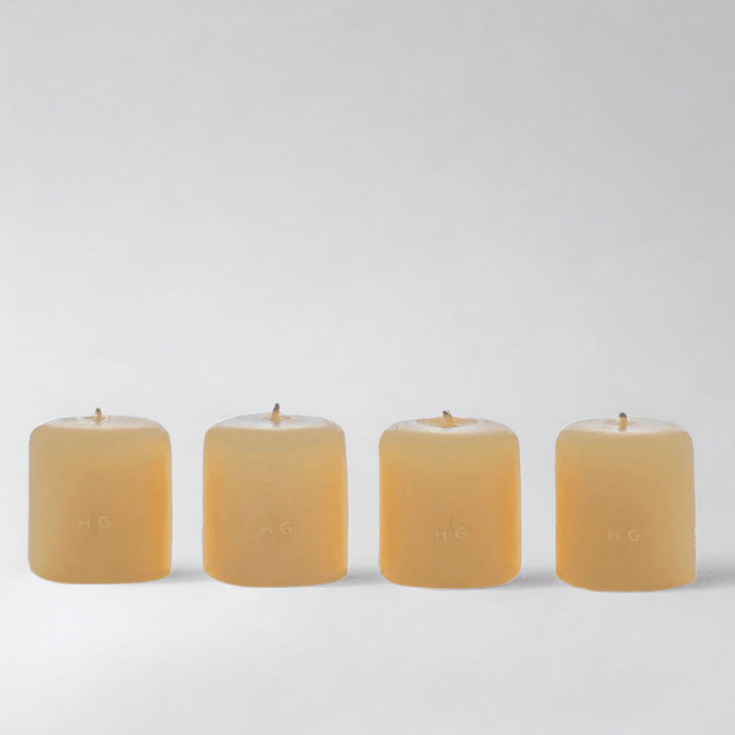 Set of 4 HG Amber Unscented 2" Votive Candles, hand-dipped paraffin with gold HG logo.