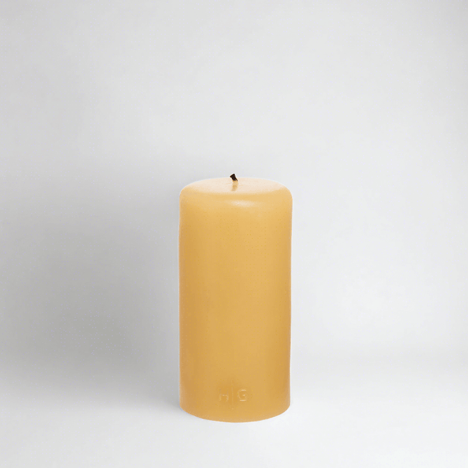 HG Amber Unscented 3"x6" paraffin pillar candle with gold embossed HG logo and cotton wick.
