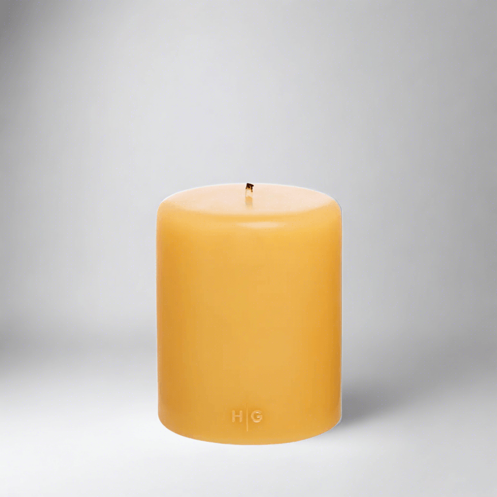 HG Amber Unscented Pillar Candle, 5"x6" paraffin, with gold HG logo and cotton wick.