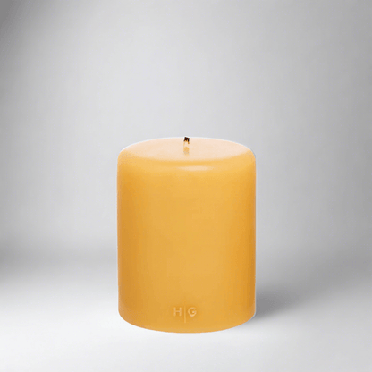 HG Amber Unscented Pillar Candle, 5"x6" paraffin, with gold HG logo and cotton wick.