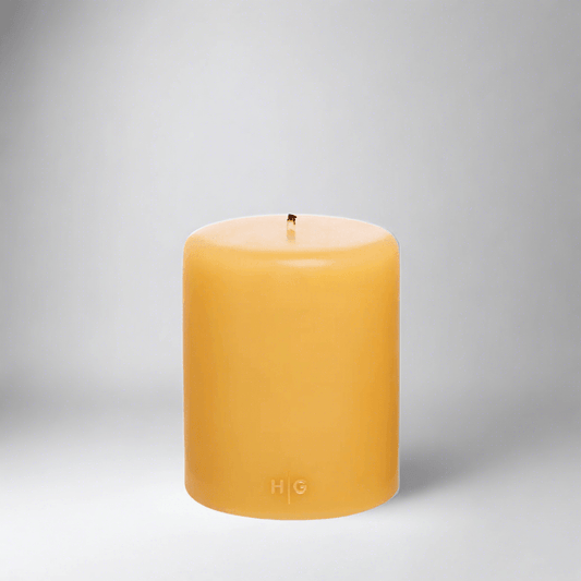 HG Amber Unscented Pillar Candle, 5"x6" paraffin, with gold HG logo and cotton wick.