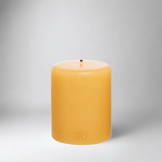 HG Amber Unscented Pillar Candle, 5"x6" paraffin, with gold HG logo and cotton wick.