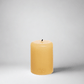 HG Amber Unscented Pillar Candle, 3"x4", hand-dipped paraffin with gold HG logo.