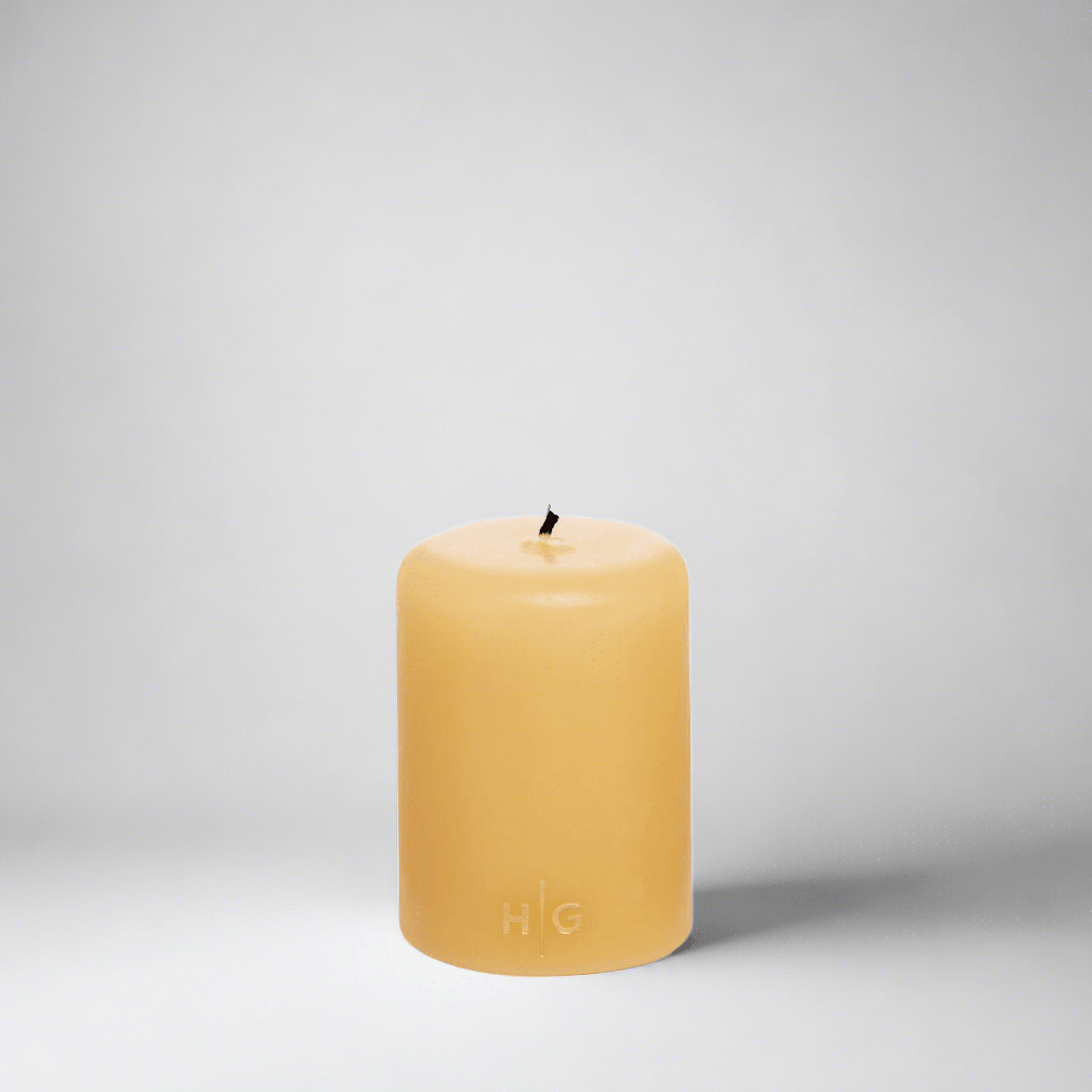 HG Amber Unscented Pillar Candle, 3"x4", hand-dipped paraffin with gold HG logo.