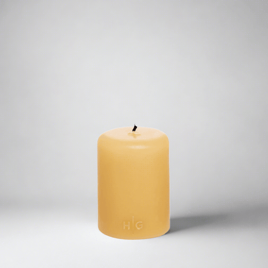 HG Amber Unscented Pillar Candle, 3"x4", hand-dipped paraffin with gold HG logo.