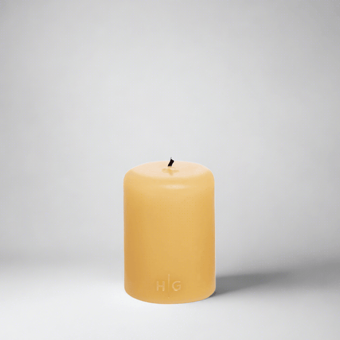 HG Amber Unscented Pillar Candle, 3"x4", hand-dipped paraffin with gold HG logo.