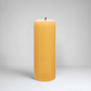 HG Amber Unscented Pillar Candle, 3"x8", with a gold embossed HG logo and black wick.
