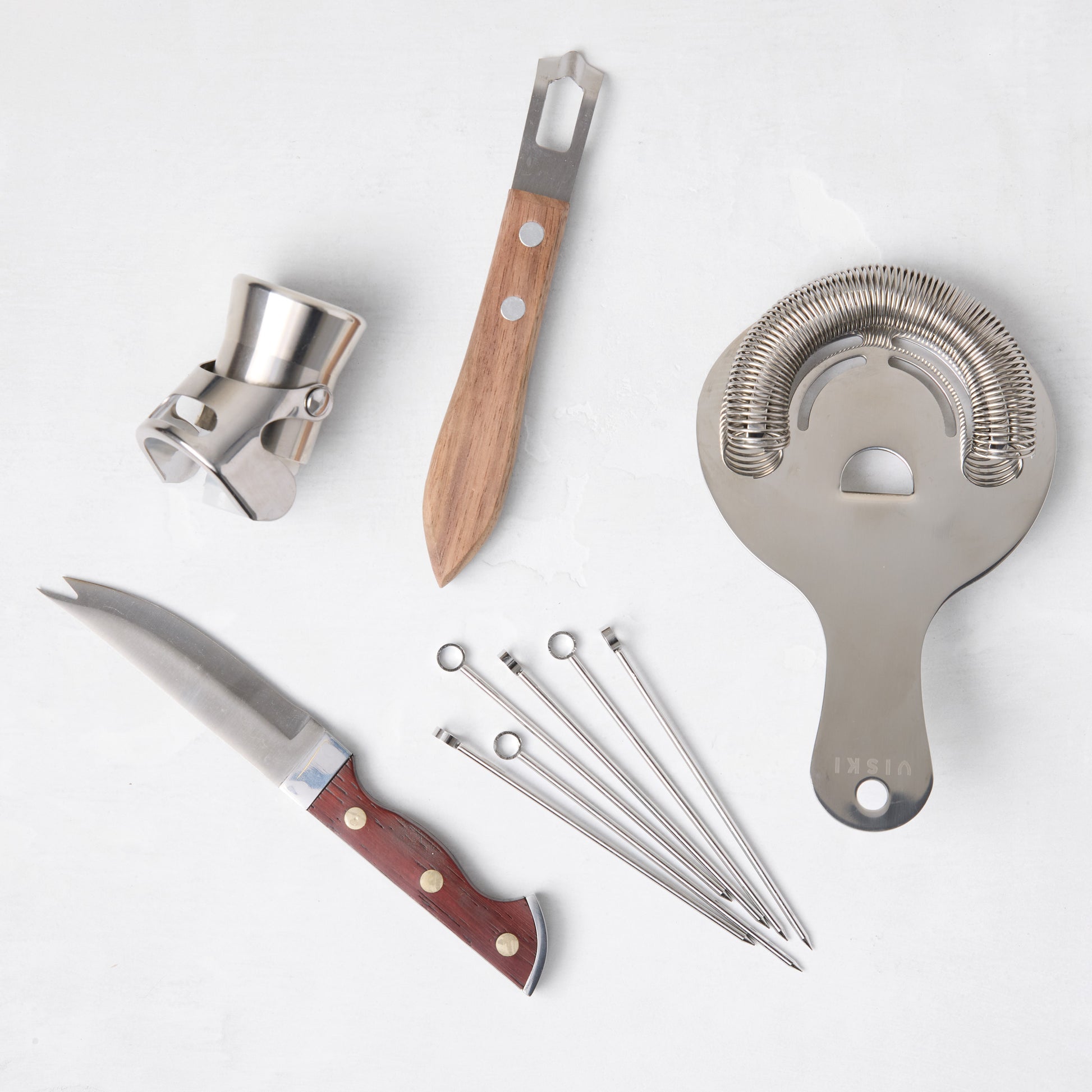 HG Bar Tool Gift Set: Silver stainless steel bar tools with wood accents, including a stopper, knife, strainer, and picks.