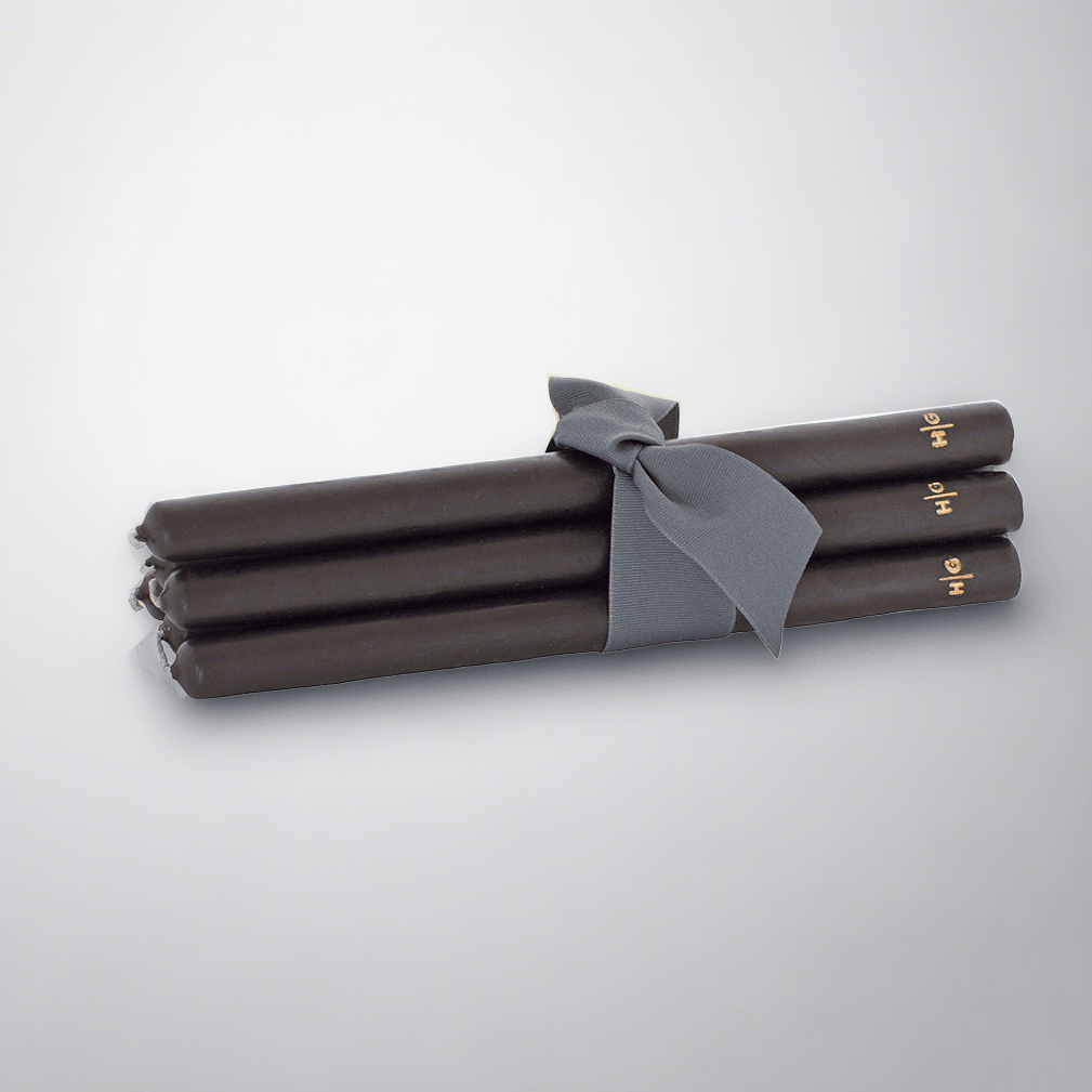 Five 12" black unscented taper candles, hand-dipped paraffin, tied with a gray ribbon, gold HG logo.