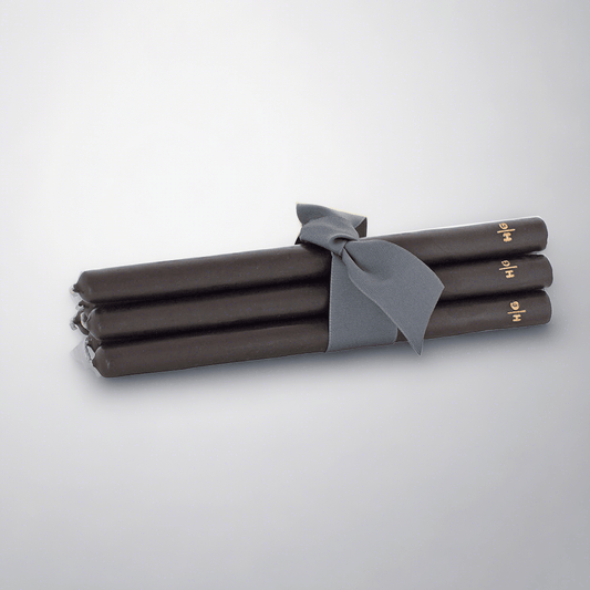 Five 12" black unscented taper candles, hand-dipped paraffin, tied with a gray ribbon, gold HG logo.