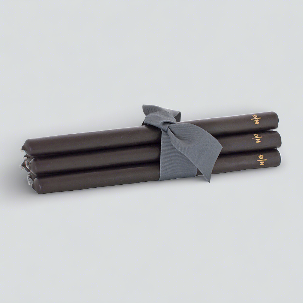 Set of 5 black 15" taper candles, hand-dipped paraffin, tied with a gray ribbon, gold HG logo.