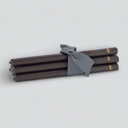 Set of 5 black 15" taper candles, hand-dipped paraffin, tied with a gray ribbon, gold HG logo.