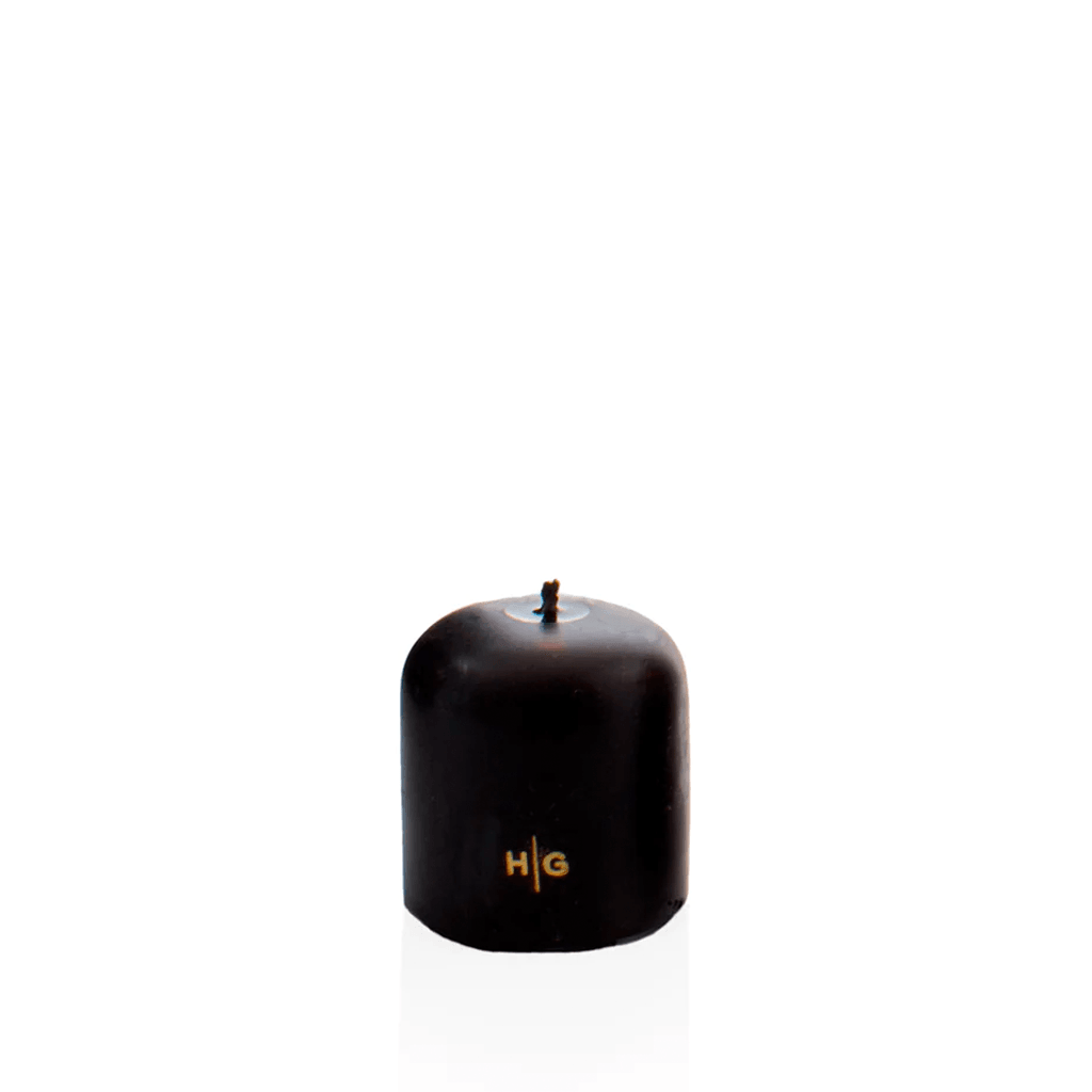 HG Black 3"x3" unscented pillar candle with gold HG logo and oversized cotton wick.