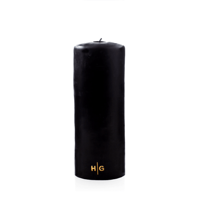 HG Black 3"x8" unscented pillar candle with gold HG logo.