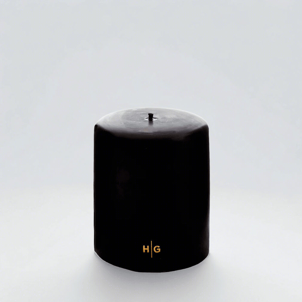 HG Black Unscented Pillar Candle, 5"x6", with gold HG logo and oversized cotton wick.