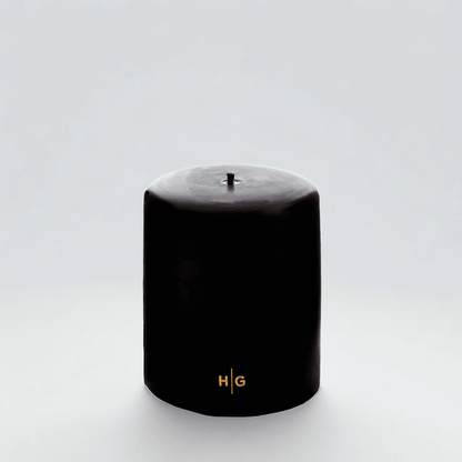HG Black Unscented Pillar Candle, 5"x6", with gold HG logo and oversized cotton wick.