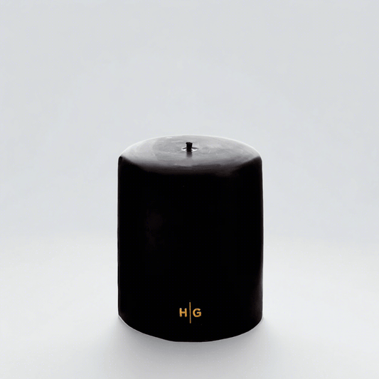 HG Black Unscented Pillar Candle, 5"x6", with gold HG logo and oversized cotton wick.