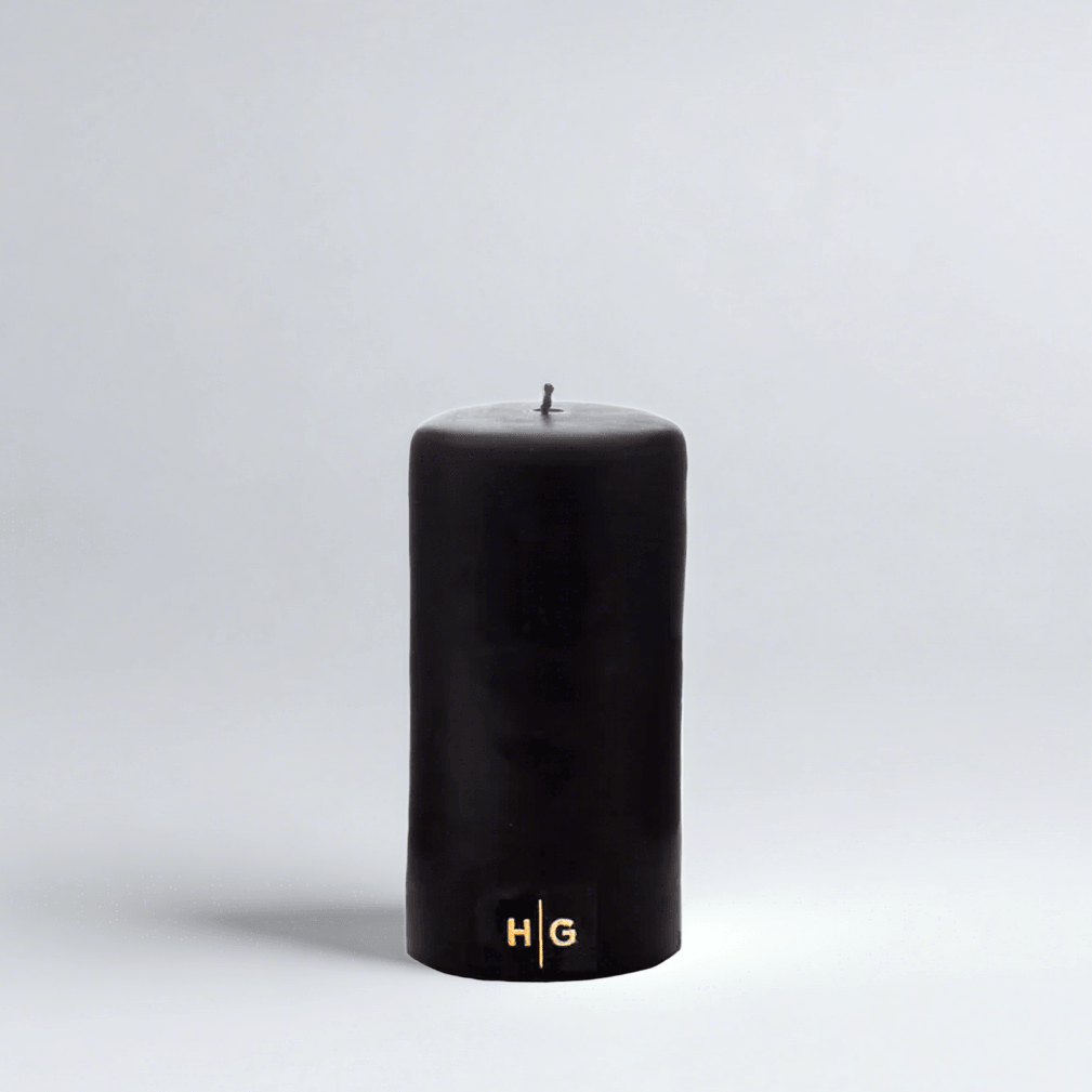 HG Black Unscented Pillar Candle, 3"x6", with a gold embossed HG logo.