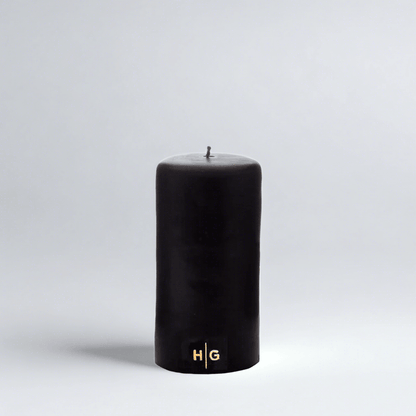 HG Black Unscented Pillar Candle, 3"x6", with a gold embossed HG logo.
