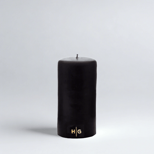 HG Black Unscented Pillar Candle, 3"x6", with a gold embossed HG logo.