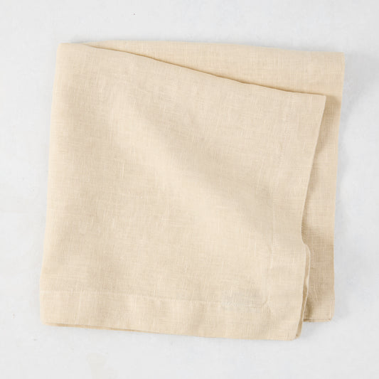 HG Buttermilk Hand-Dyed Linen Napkin, 22", folded, light beige with subtle texture.
