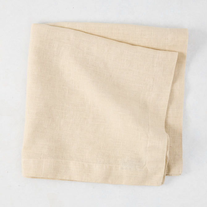 HG Buttermilk Hand-Dyed Linen Napkin, 22", folded, light beige with subtle texture.